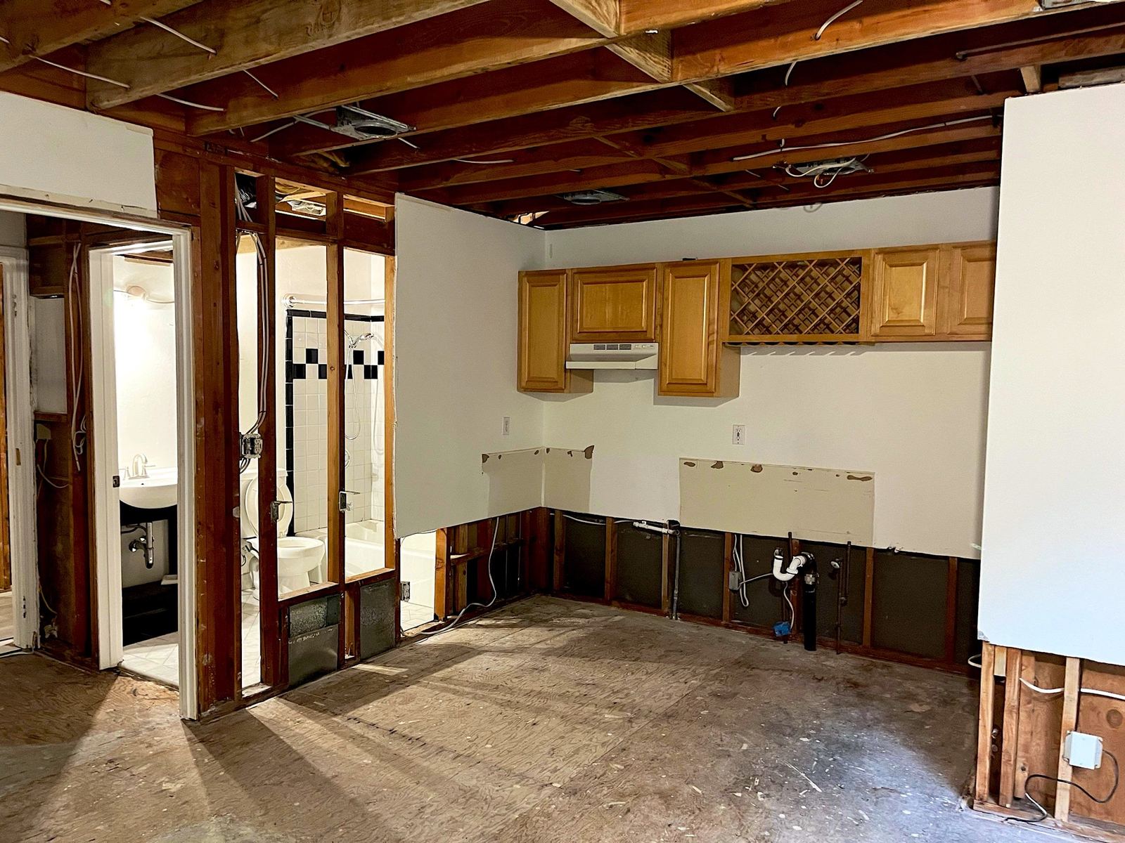Kitchen with lower drywall and ceiling removed after water damage